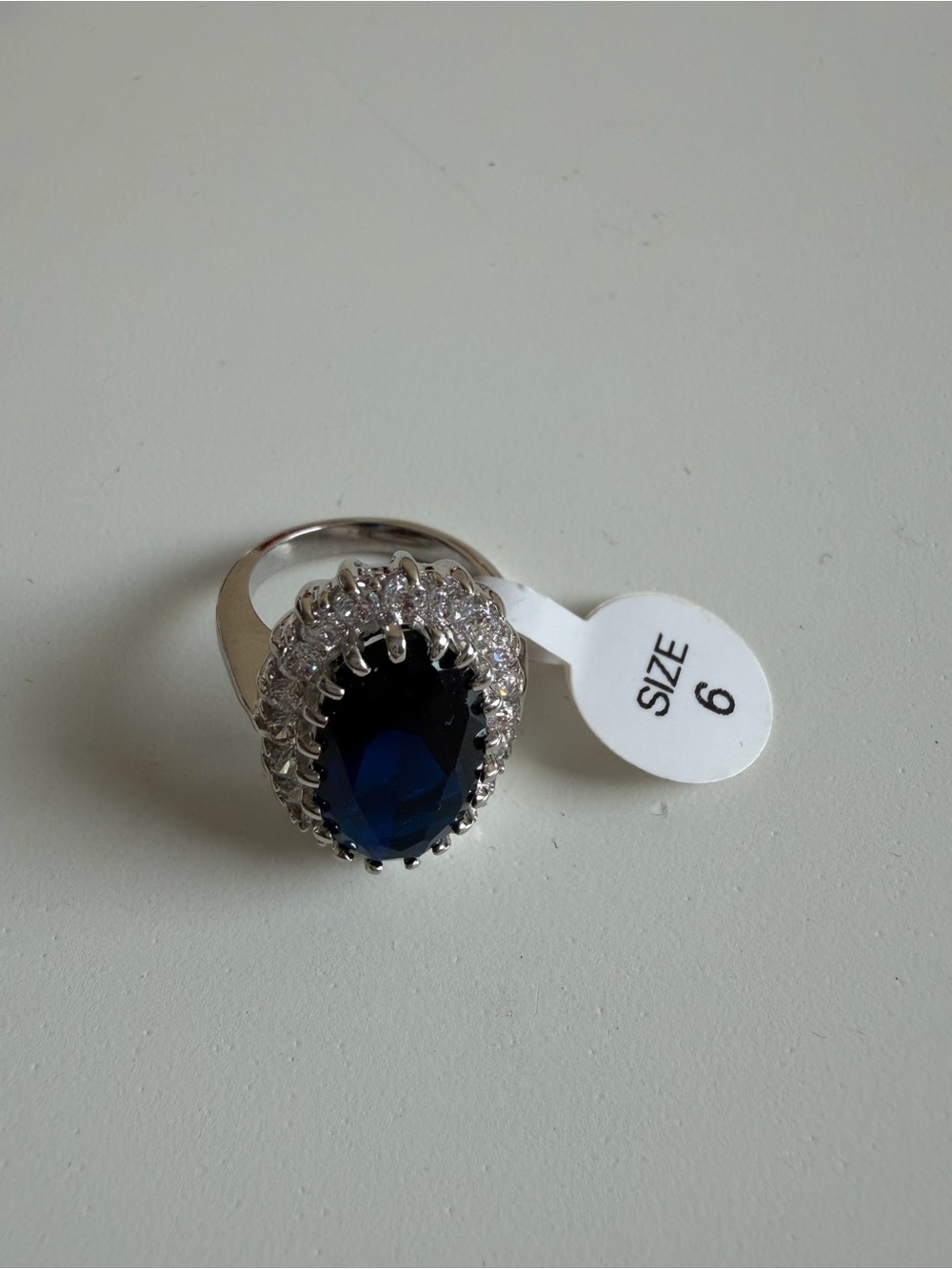 Silver Ring with Deep Blue Oval Stone and Clear Halo - Size 6